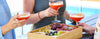 People holding cocktails with a charcuterie board in the foreground