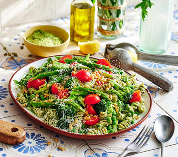 Layered veggie-loaded pesto pasta