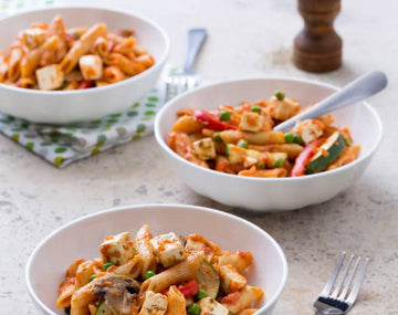 Tomato pasta with vegetables and feta