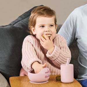 Baby with silicone bowl and sippy cup with straw